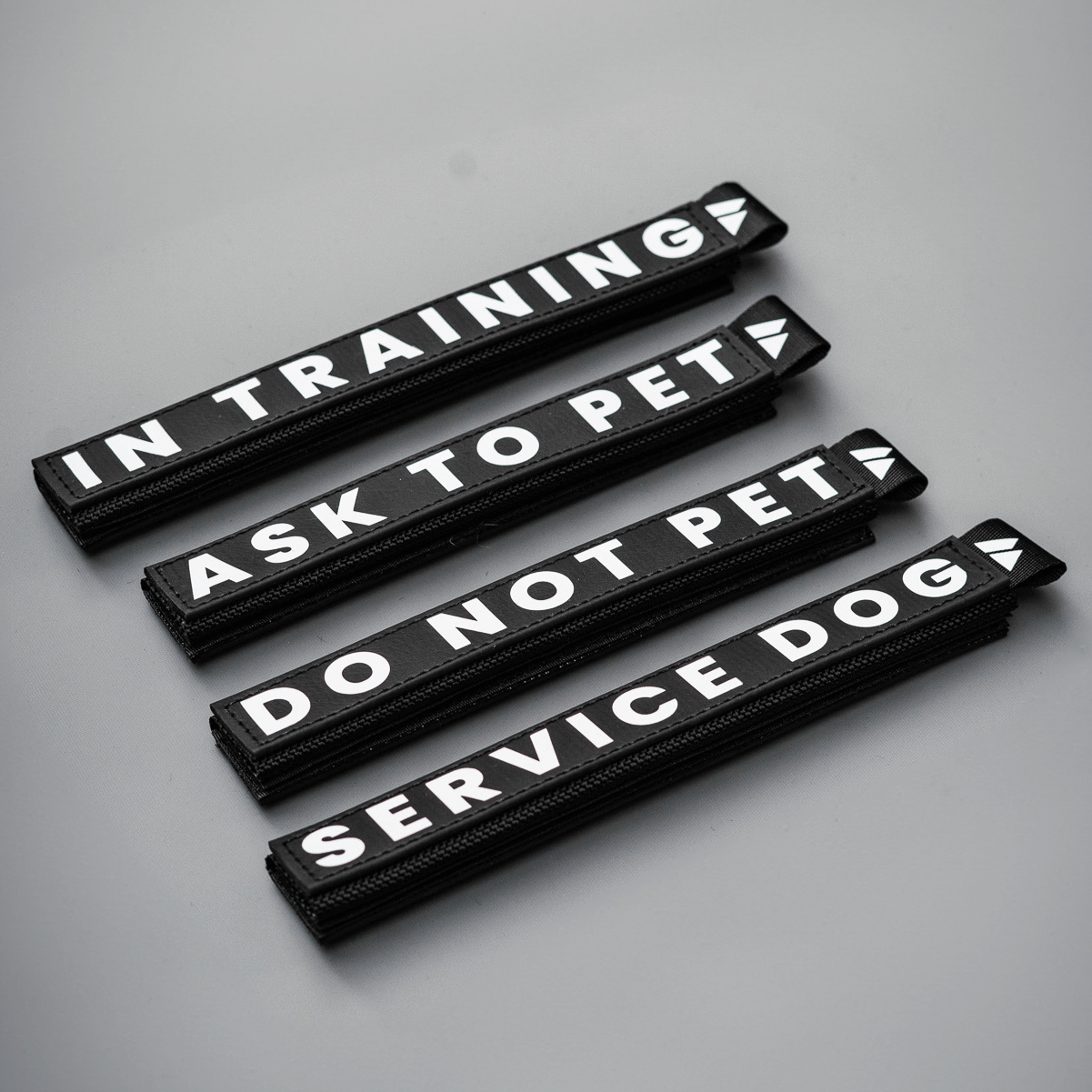 Slim waterproof BioThane leash wraps with reflective lettering featuring "In Training," "Ask to Pet," "Do Not Pet," and "Service Dog."