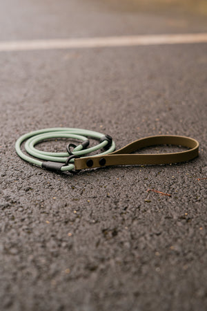 Hybrid Handle BioThane® Rope Slip Lead on asphalt, featuring a comfortable two-tone design with a durable handle.