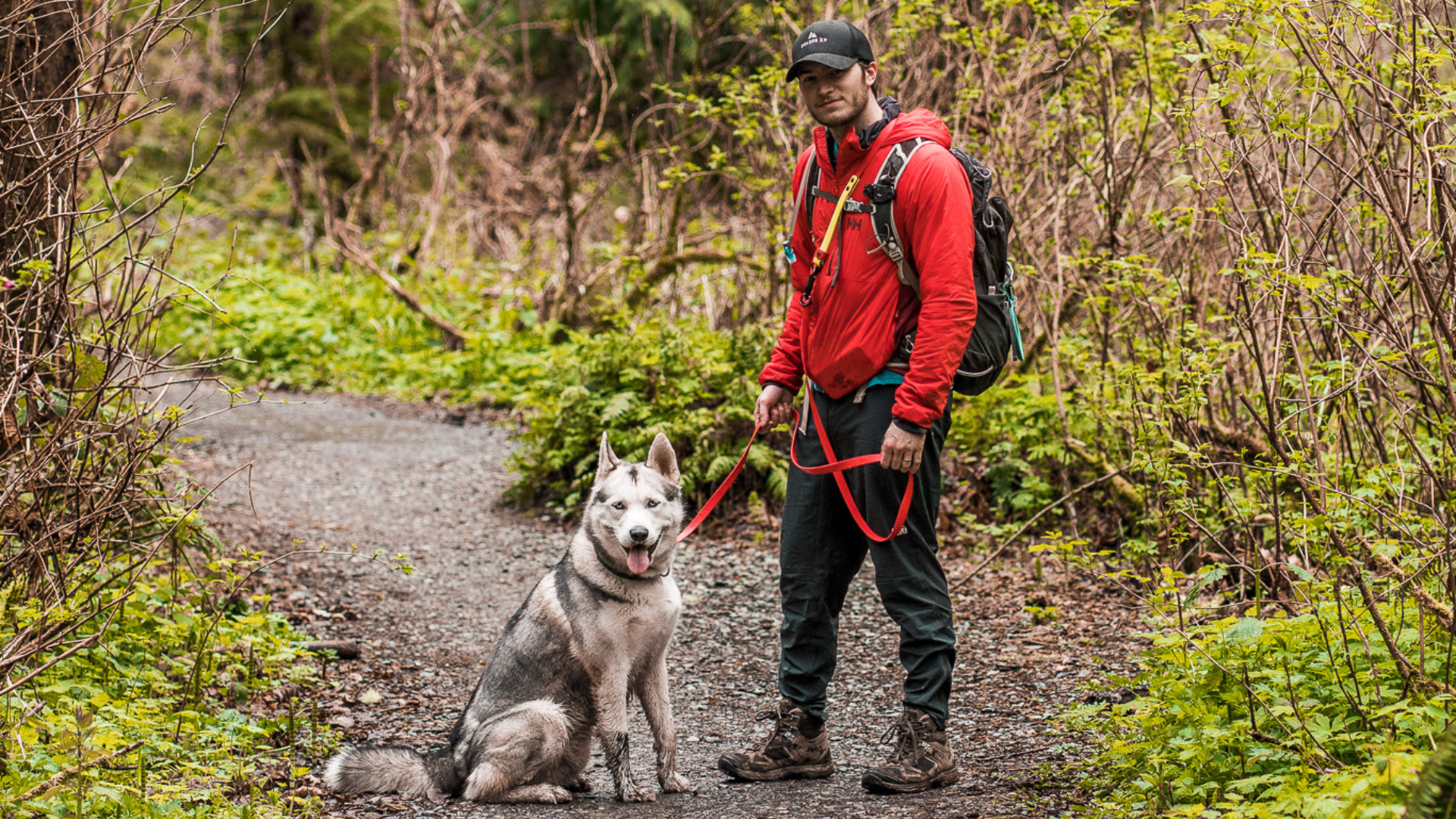 man hiking with husky using biothane dog leash
