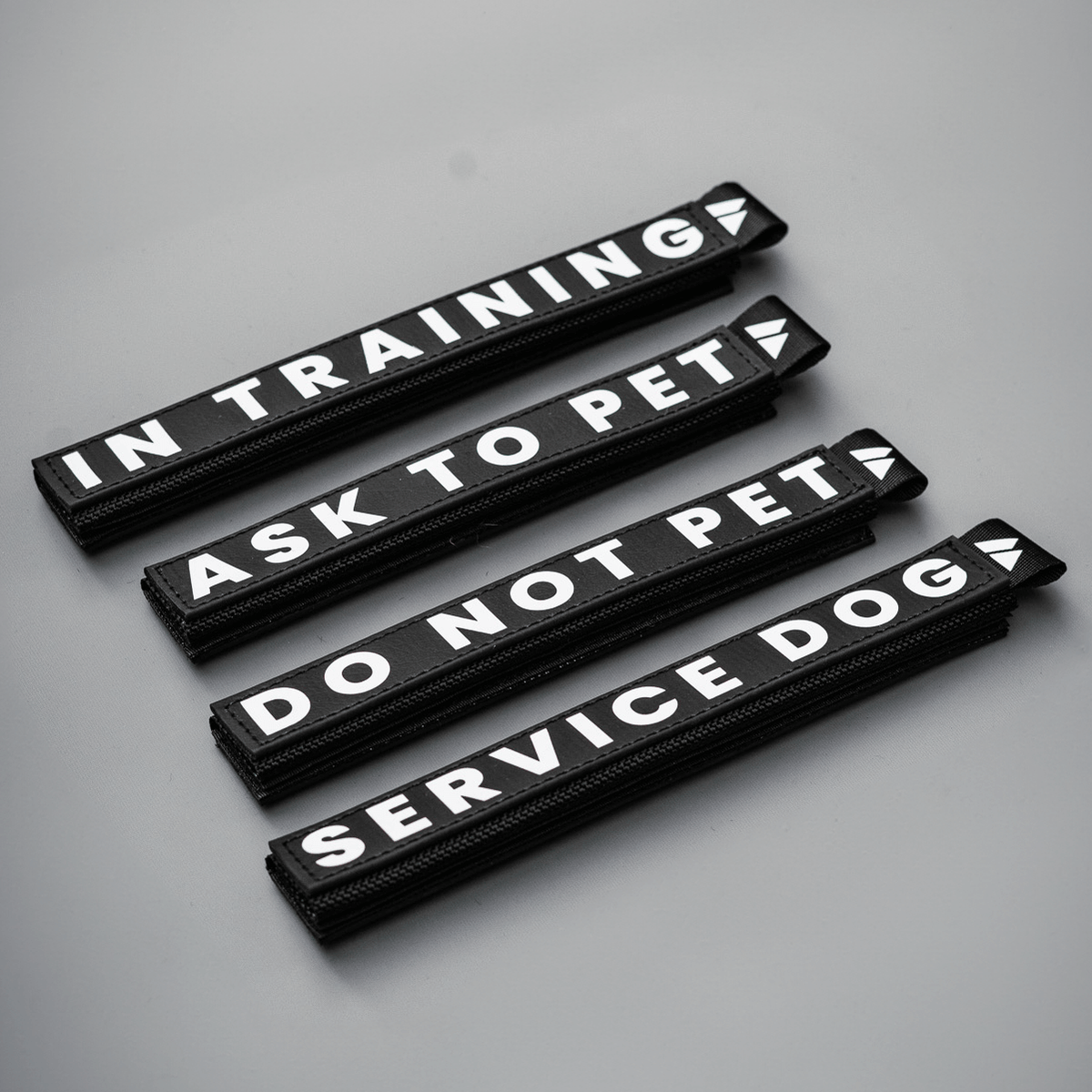 Slim waterproof BioThane leash wraps with reflective lettering featuring "In Training," "Ask to Pet," "Do Not Pet," and "Service Dog."