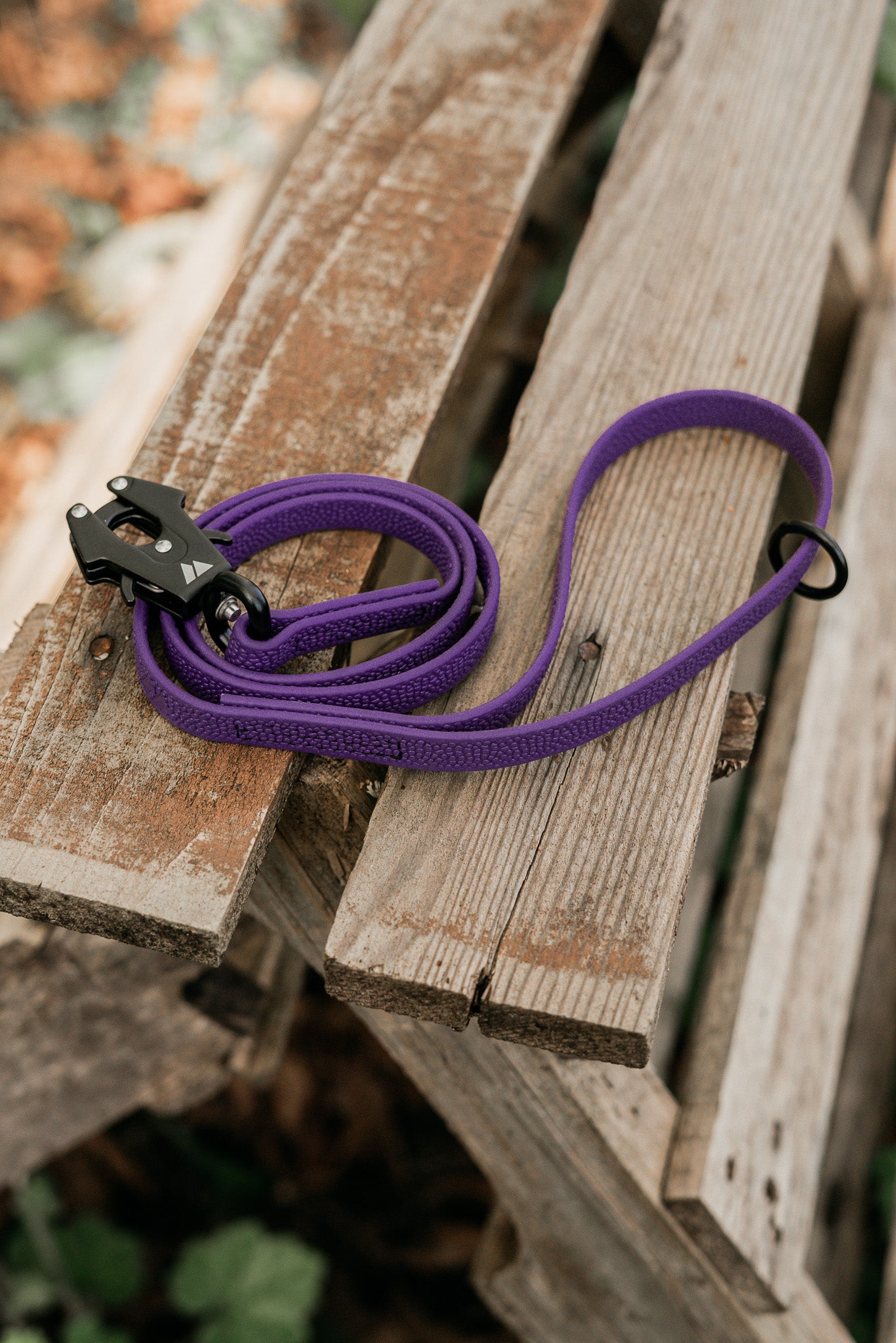 Purple Pebble Grip BioThane® dog leash on wooden surface, showcasing durability and tactile grip.